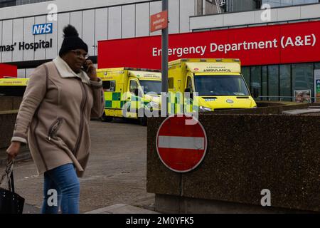 London, UK. 07th Dec, 2022. A woman walks past St Thomas' Hospital/ More than 10,000 NHS ambulance staff from nine NHS hospital trusts in England and Wales will walk out on 21 December in a dispute over pay, the trade union GMB has announced. Credit: SOPA Images Limited/Alamy Live News Stock Photo