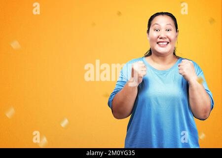 Portrait Of A Fat Woman With A Big Smile Against A Yellow Wall