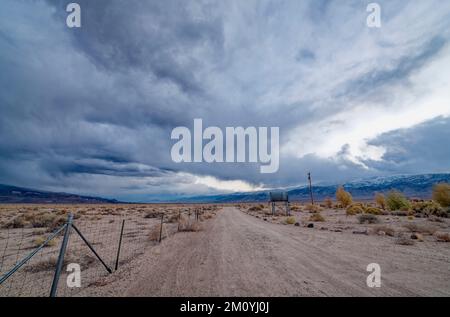 Storm clouds gathering over a dirt road in the desert in western Nevada, USA Stock Photo