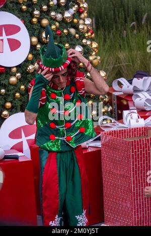 christmas elf in front of a christmas tree with gifts, mexico Stock Photo