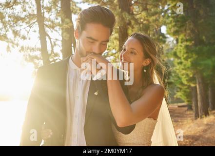 I cant imagine being with anyone else. an affectionate bride and groom outside on their wedding day. Stock Photo