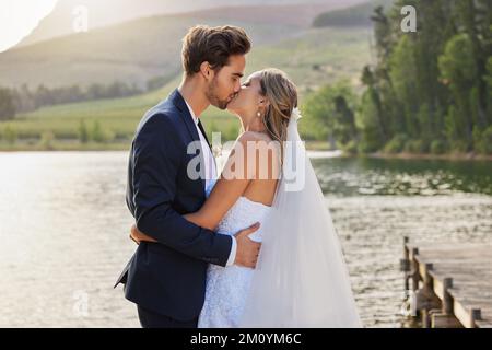 Youve made me the happiest man in this world. an affectionate bride and groom outside on their wedding day. Stock Photo
