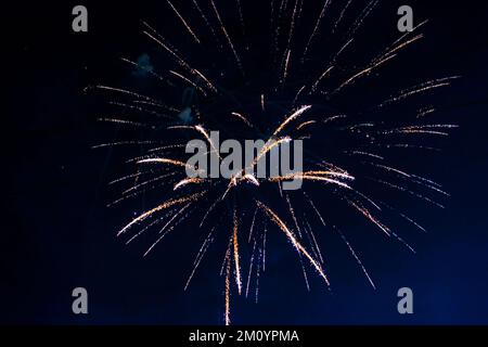 An explosion of bright single fireworks, against the background of the night sky. High quality photo Stock Photo