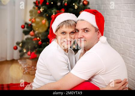 Christmas celebration. Portrait of a young couple in their living room Stock Photo