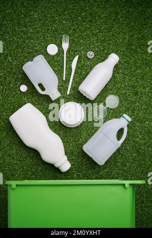 Plastic collected for recycling on green grass background. Concept of zero waste, eco lifestyle and sustainable living Stock Photo