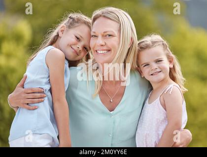 Families are like fudgemostly sweet with a few nuts. a woman spending time outdoors with her two daughters. Stock Photo