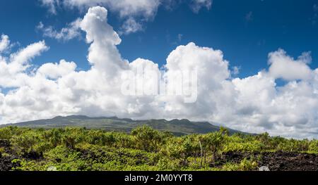 Panorama of storm clouds forming over mountains above a tropical landscape of Waiʻanapanapa State Park, Maui Stock Photo