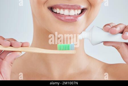 For the perfect smile. an unrecognizable young woman posing in studio against a grey background. Stock Photo