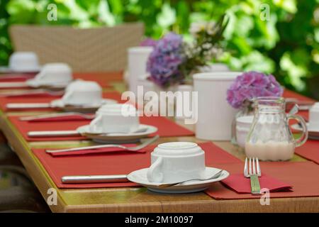 A table set for a celebration in the outdoor area of a restaurant Stock Photo