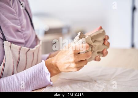 Unrecognisable Female Potter Master Preparing Pile of Clay to Creating Pot on Pottery Wheel in Her Ceramic Studio. High quality photo Stock Photo