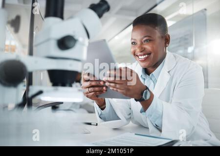 The days discoveries are always interesting. a young scientist using a digital tablet while working in a lab. Stock Photo