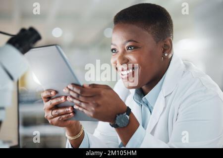 My work directly impacts the world. a young scientist using a digital tablet while working in a lab. Stock Photo