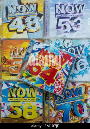 Closeup of colourful NOW That's What I call Music CD Covers Stock Photo