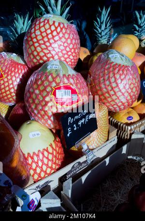 Pomelo fruit (Citrus Maxima), a large Asian citrus fruit related to grapefruit, on display outside a greengrocers shop Stock Photo