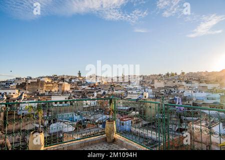 Medina of Fez skyline with pigeons resting on rooftop terrace at sunset, Fez, Morocco, North Africa Stock Photo