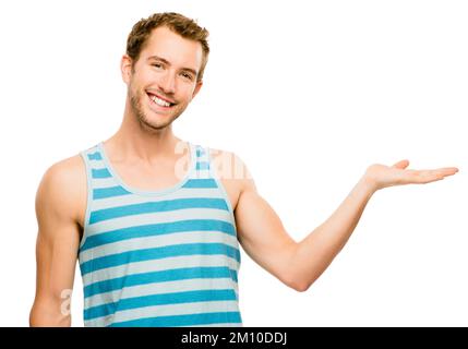Happiness knows no bounds. a young man gesturing to an empty space against a studio background. Stock Photo