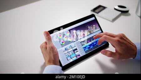 Video Editor Or Designer Using Editing Software Tech On Tablet Stock Photo
