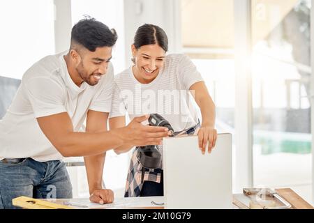 Go straight into the corner. a young couple standing together and using a power drill at home. Stock Photo