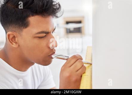 This is where I draw the line. a man using a spirit level while renovating a house. Stock Photo
