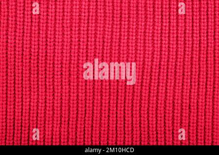 Knitted fabric texture. Demonstrating Viva Magenta - trendy color of the year 2023 background, texture. Abstract pattern. Stock Photo