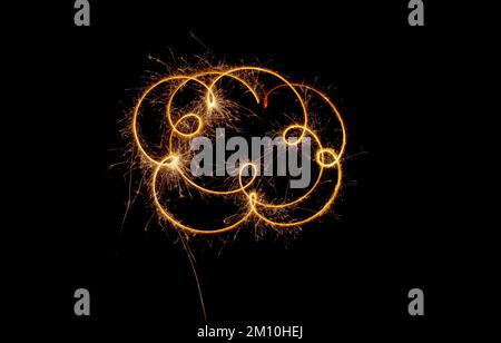 Sparks of a sparkler on a black background. A light moving in the dark. Stock Photo