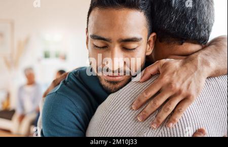 Ill always come back for a hug. a father and son hugging at home. Stock Photo