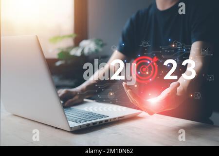 2023 Success business concept with Businessman hand hold typing laptop (notebook) of Futuristic technology, networking system, big data, investment, f Stock Photo