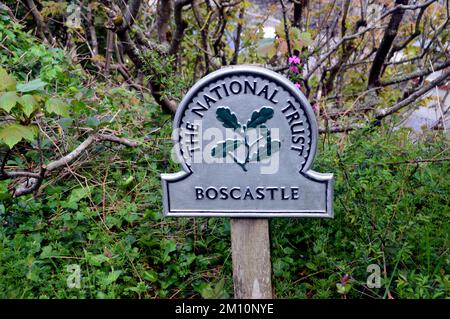 Metal National Trust Sign on a Wooden Post for Boscastle from the South West Coastal Path in Cornwall, England, UK. Stock Photo