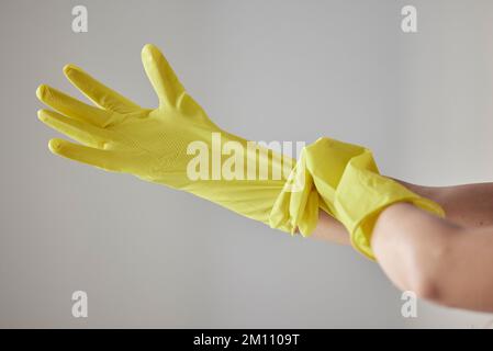 Hands, yellow rubber gloves and cleaning woman ready for worker cleaning service, spring cleaning or housework in studio background. Maid, hygiene Stock Photo