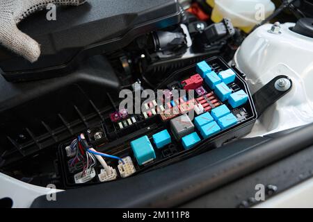 Close up photo of man checking details of automobile Stock Photo