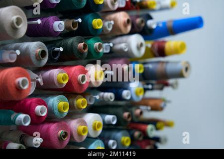 Multi-colored spools of thread on special holders Stock Photo
