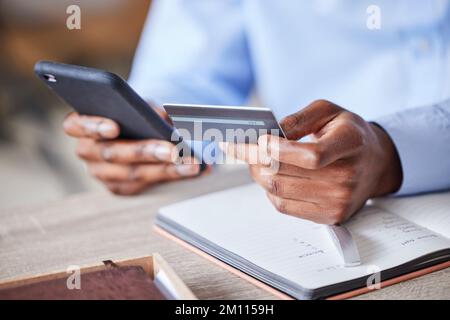 Businessman, hands and credit card, smartphone banking or ecommerce accounting of investment, budget or fintech finance at office desk. Closeup Stock Photo