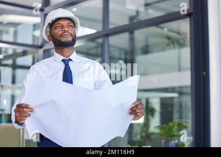 Black man, architect and blueprint in construction planning, thinking or contractor at the office. African American male engineer holding project plan Stock Photo