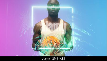 Portrait of bald african american basketball player holding ball by glowing rectangle and plants. Composite, serious, copy space, sport, competition, Stock Photo