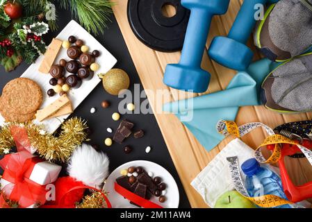 Comparison of healthy habits after the Christmas holidays with food banquets and calorie consumption. Top view. Stock Photo