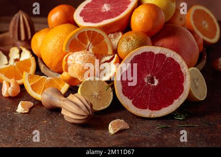 Citrus fruits on a old brown table. Presented are oranges, grapefruits, lemons, and tangerines. Stock Photo