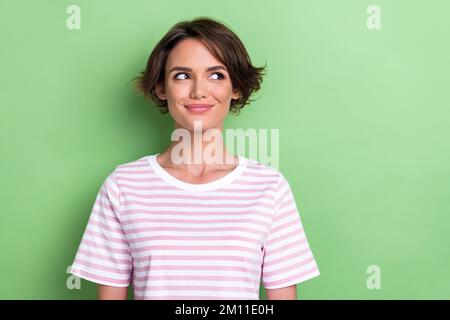 Photo of lovely bob hairdo young lady look promo wear white striped t-shirt isolated on green color background Stock Photo