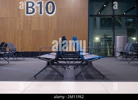 lounge at the airport from the side angle. indoor, benches where no one sits. indoors, empty lounge. Stock Photo