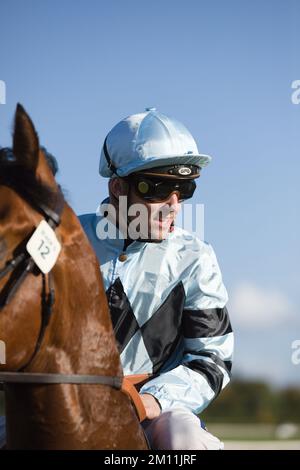 Jockey Kevin Stott waiting at the starting gates at York Races. Stock Photo