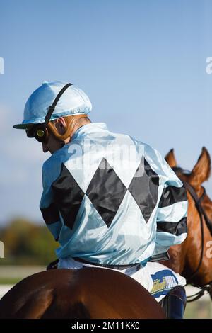 Jockey Kevin Stott waiting at the starting gates at York Races. Stock Photo