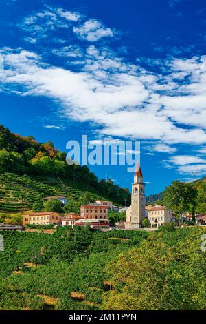 A church tower rises in the middle of a dreamlike landscape, Veneto, Northern Italy Stock Photo