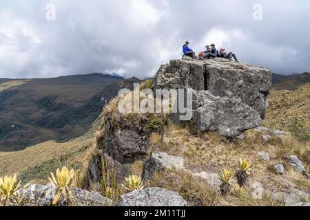 South America, Colombia, Department of Antioquia, Colombian Andes, Urrao, hikers take a break on a boulder at ramo del Sol Stock Photo