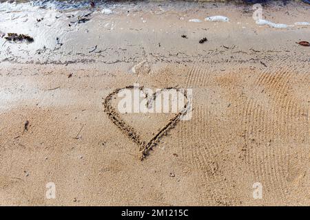 heart-symbol - as a message written with a finger in the sand on a beach with waves and blue ocean at Mauritius Island, Africa, top view, nobody Stock Photo