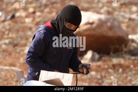 A masked Palestinian Protester seen during the Palestinian demonstration against Israeli settlements in the village of Beit Dajan near the West Bank city of Nablus. (Photo by Nasser Ishtayeh / SOPA Images/Sipa USA) Stock Photo