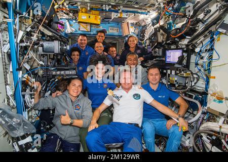 ISS - 12 October 2022 - The eleven Expedition 68 crew members aboard the International Space Station pose for a portrait. In the front row from left, Stock Photo