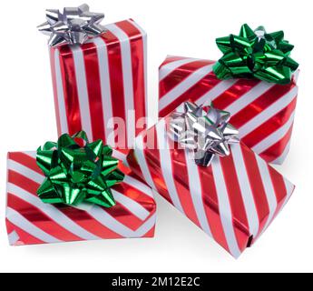 A pile of many gift boxes for chrirtmas, red and white striped wrapping paper with green and silver bows isolated on white. Stock Photo