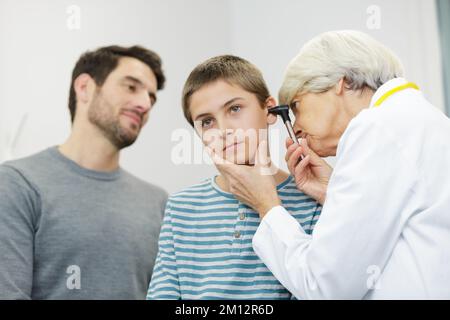 the doctor examines the childs ear Stock Photo