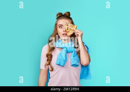 woman covering her eyes with slice of fresh pizza Stock Photo