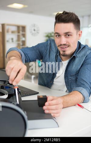 man replacing ink cartridge in his home printer Stock Photo