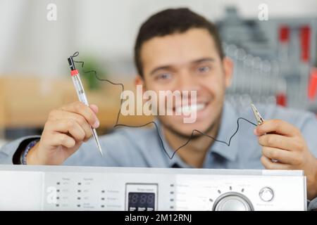 serviceman holding device for testing power Stock Photo